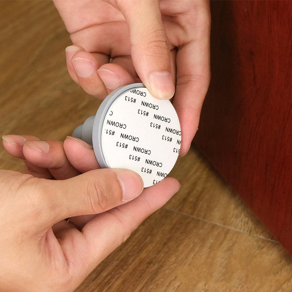 Adhesive door stopper
